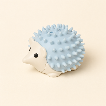 Nadenade Groomer, a soft rubber hedgehog with a spiked dome seated on a cream base